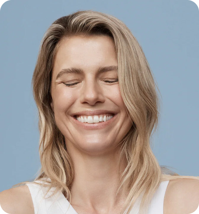 smiling woman with eyes closed