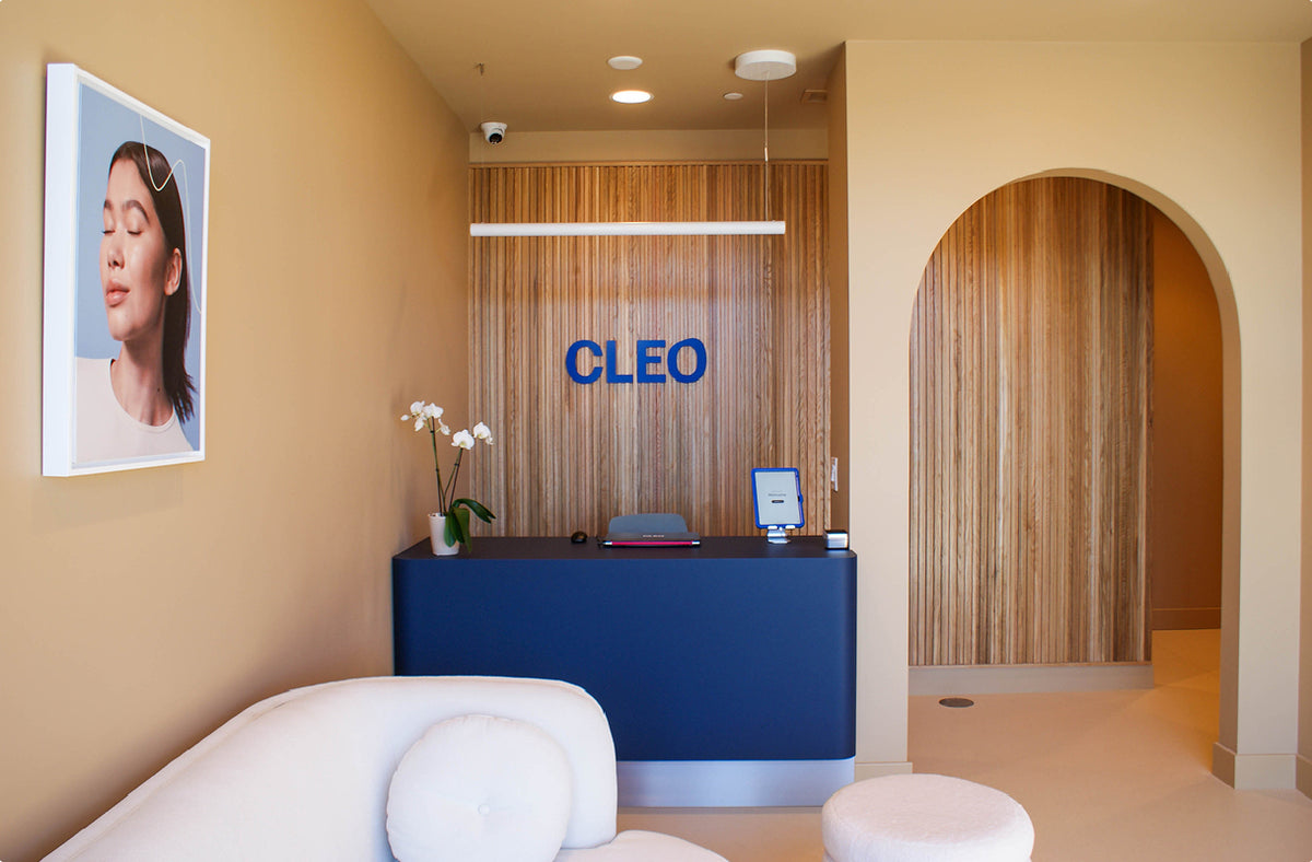 Modern office interior with a reception desk and 'CLEO' branding.