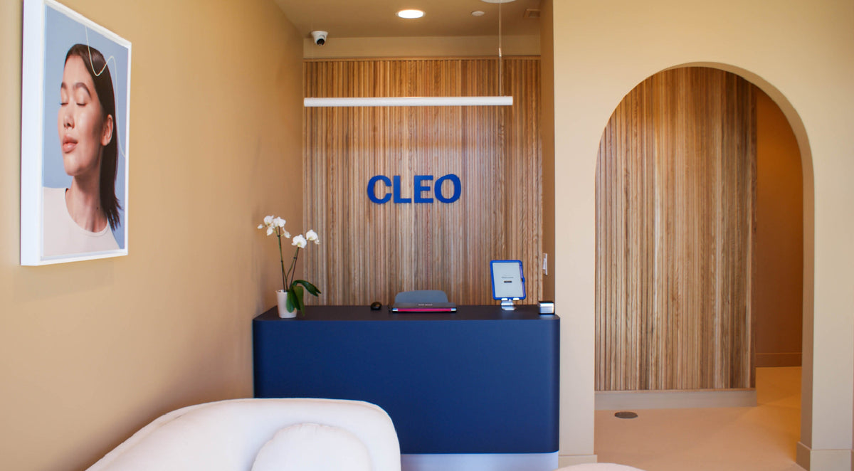 Modern office interior with a reception desk, wall art, and 'CLEO' branding.