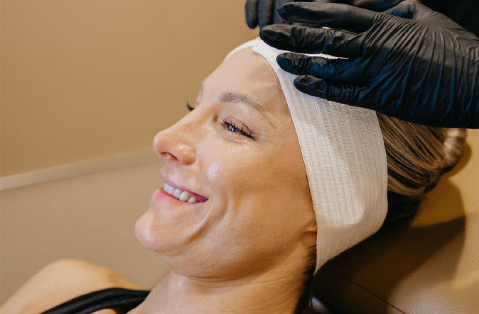 Woman with protective bandage on forehead