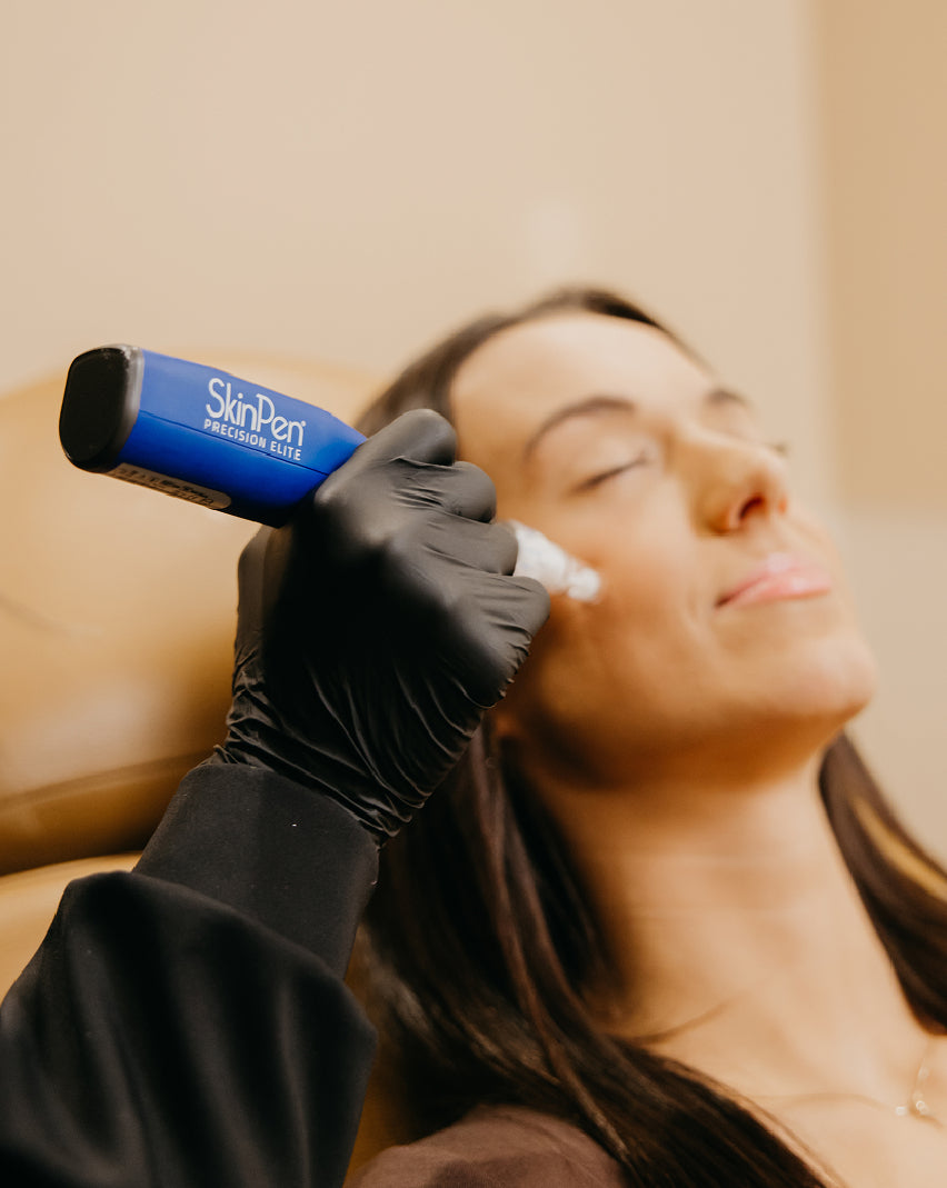 Woman receiving facial treatment