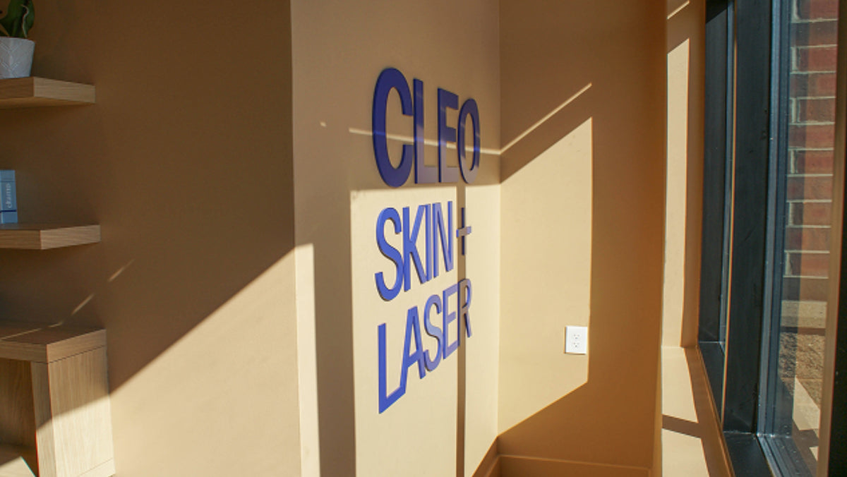 Cleo Skin Laser sign on a beige wall with shelves and a window in the background