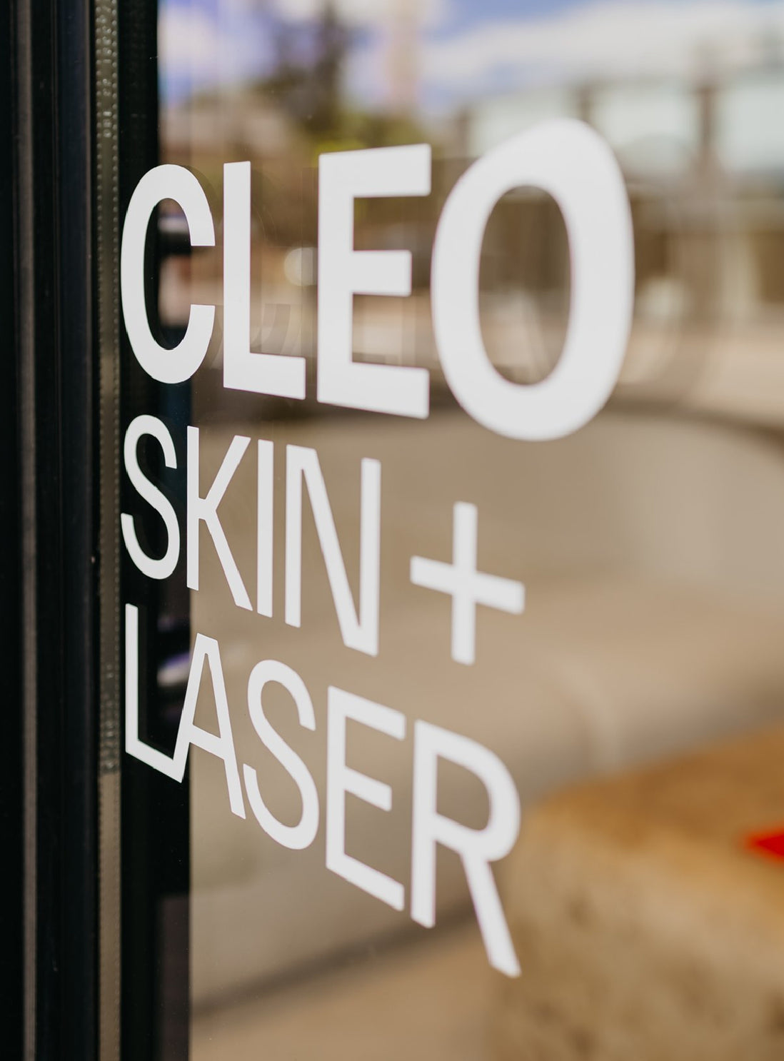 Cleo Skin + Laser branding on door