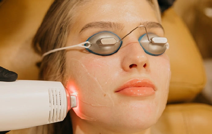 Woman wearing eye protection and receiving contour facial treatment