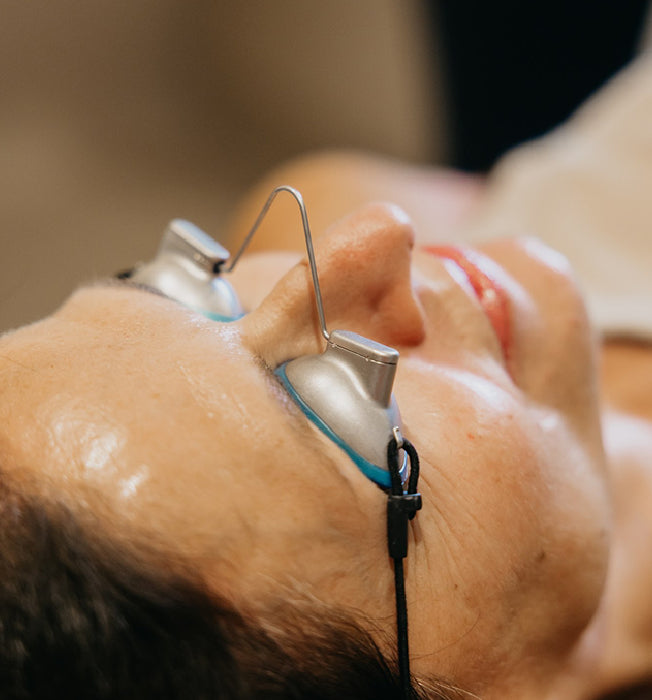 Person lying down with protective eye gear on