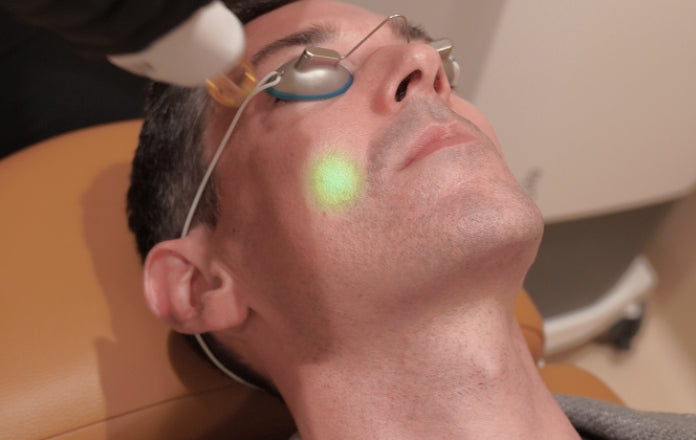 Man receiving glass skin laser facial treatment 