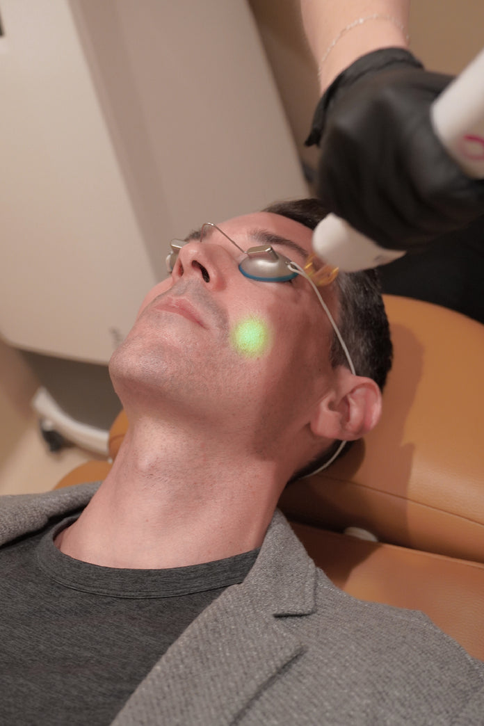 Man receiving glass skin laser treatment on face