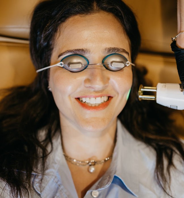 Woman receiving laser facial treatment