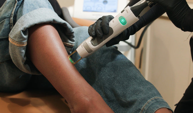 Person receiving laser treatment on shin