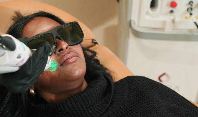 Woman receiving laser treatment on face