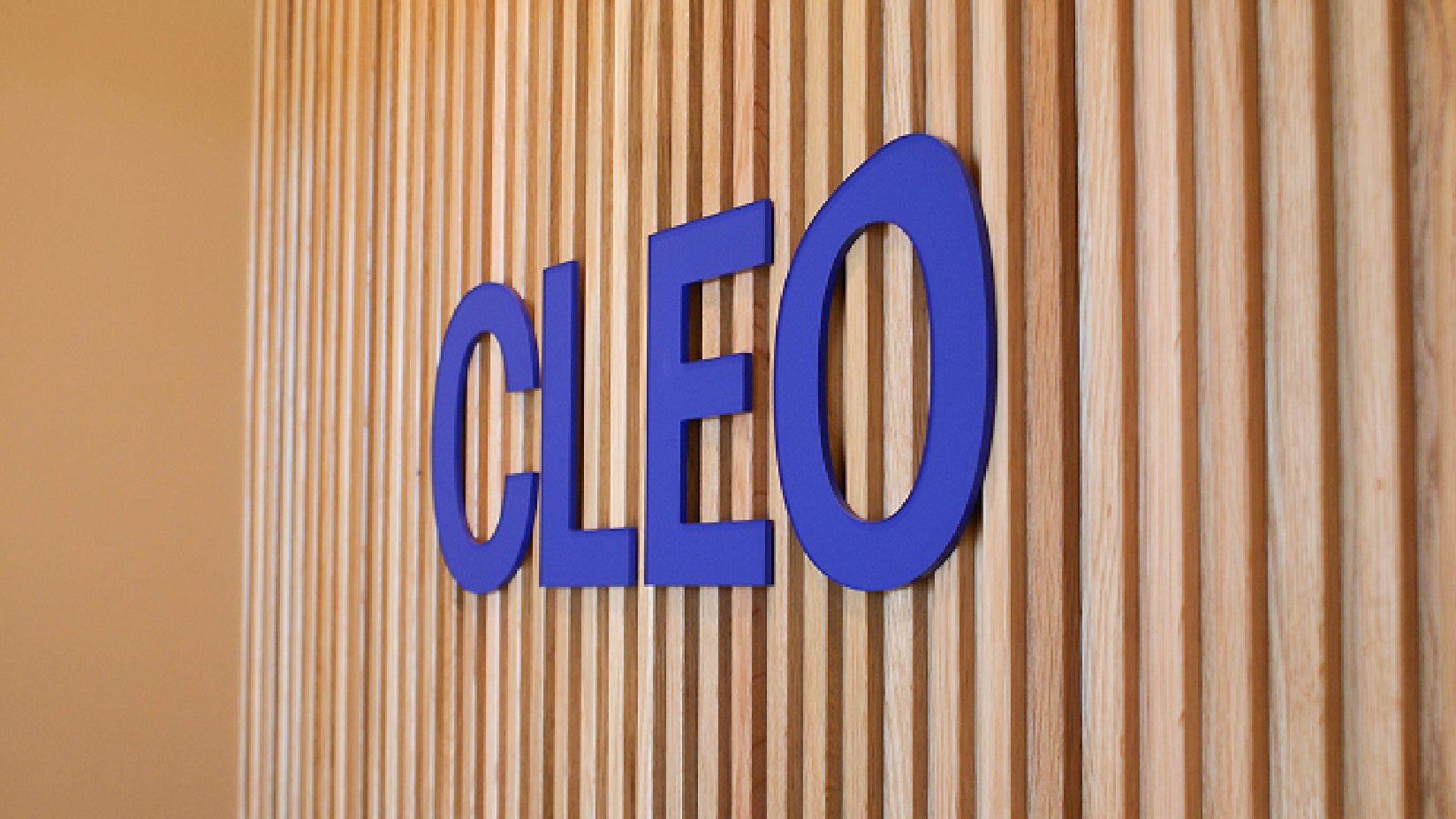 Cleo sign on wood panel wall