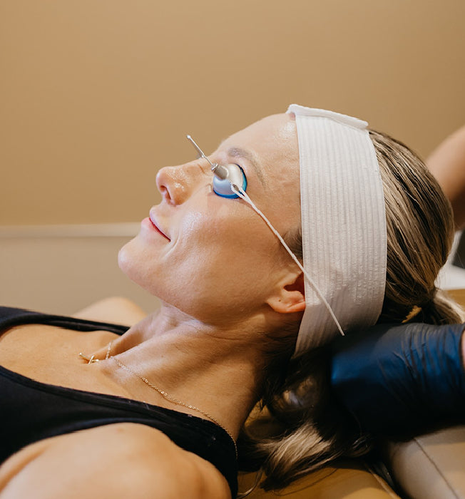 Woman reclining with protective eye gear on